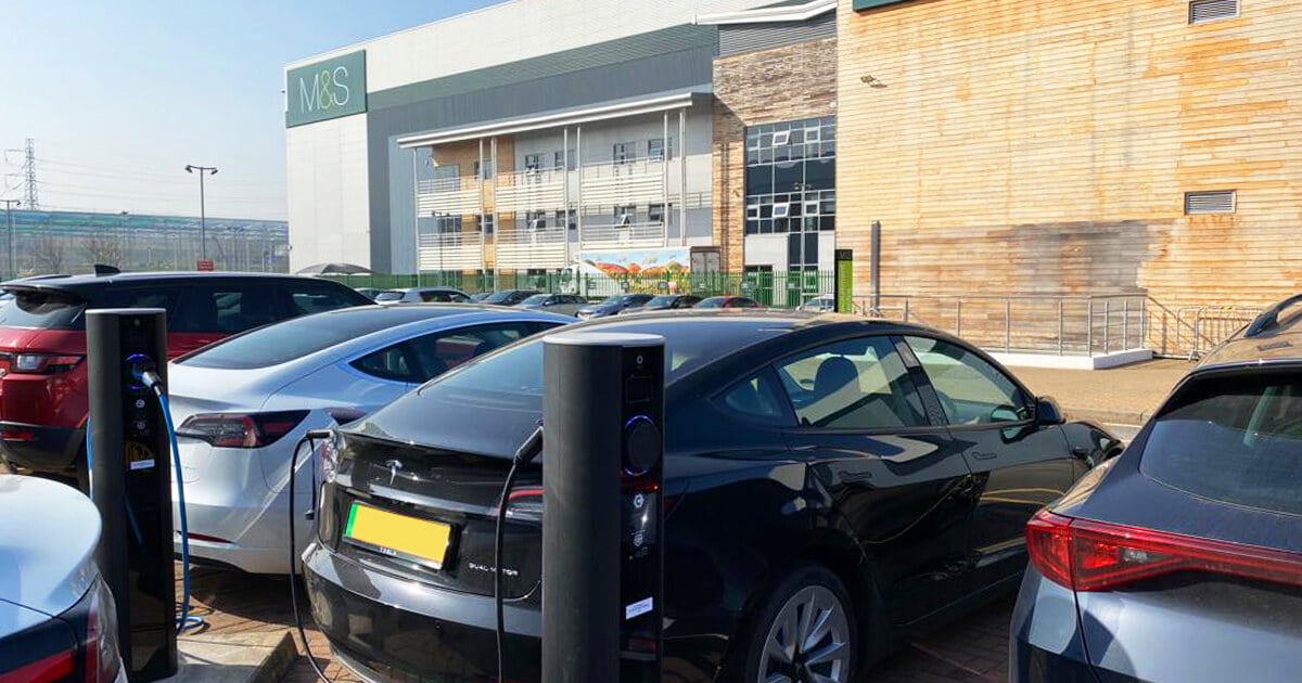 row of cars charging in car park