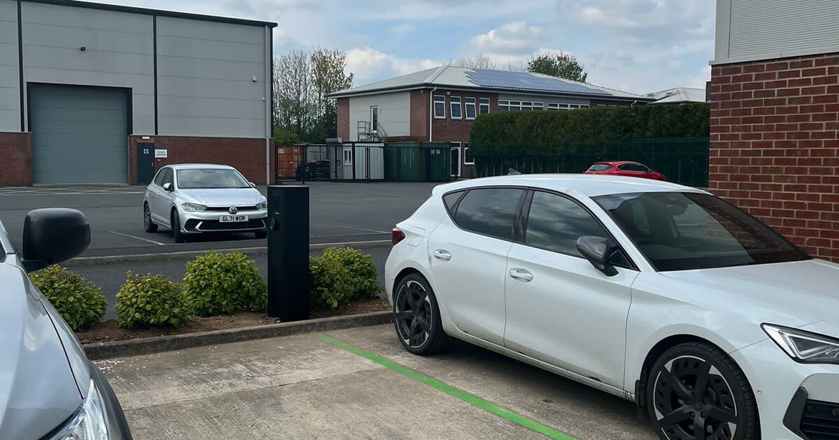 white car in car park charging